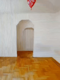 A pixelized photo of a balloon in an empty room