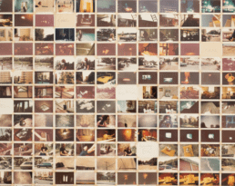 photograph of a wall of small photographs, details fuzzy